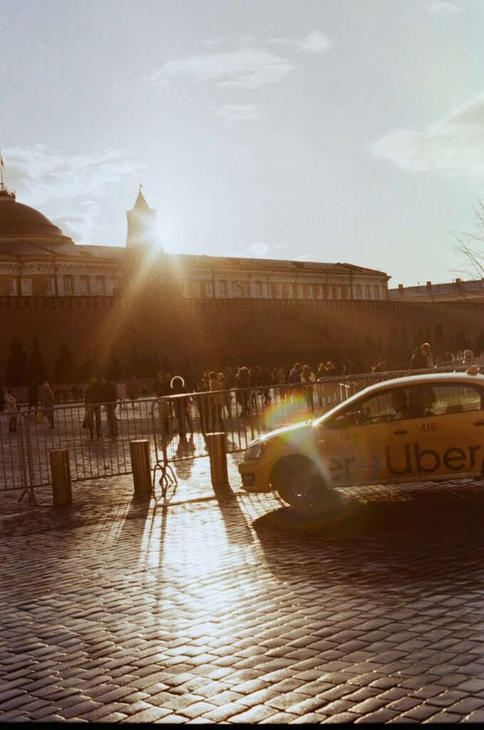 A sunny day at Red Square in Moscow featuring an Uber taxi and neoclassical architecture.